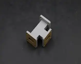 What are the advantages of using a Waveguide Power Divider in microwave communication?